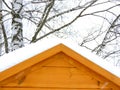 White snow on the roof of wooden house in winter Royalty Free Stock Photo