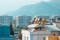 View of the roofs of houses with solar panels and water barrels. Concept Modern technologies, electricity savings