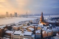 View of the roofs of the old city and the tower of the Dome Cathedral against background of an ice-covered river. Royalty Free Stock Photo