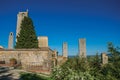 View of rooftops and towers with trees and blue sunny sky at San Gimignano. Royalty Free Stock Photo