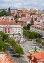 Rossio Square, the Column of Pedro IV, the Queen Maria II National Theatre, fountain and the orange rooftops from Royalty Free Stock Photo