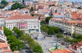 Rossio Square, the Column of Pedro IV, the Queen Maria II National Theatre, fountain and the orange rooftops from Royalty Free Stock Photo