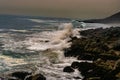 view of the rough waves breaking against the rocks on the coast of the Valparaiso Region, Chile, at sunset Royalty Free Stock Photo