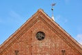 View of a round window on an old red brick wall of a house or home. Glass with metal frame on historic church building Royalty Free Stock Photo