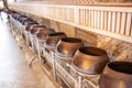 View of row of many bronze bowls standing on long stand