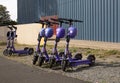 View of a row of parked rental electric scooters