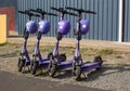 View of a row of parked rental electric scooters