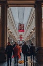 View of Royal Gallery of Saint Hubert shopping arcades in central Brussels, Belgium, people walk on foreground Royalty Free Stock Photo