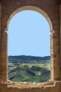 View from a ruined window on green fields Royalty Free Stock Photo