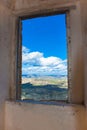 View from a ruined window on green fields Royalty Free Stock Photo