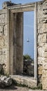 View of the ruins of the ancient Greek city of Chersonesos on the Black Sea shore with a yacht on horizon on the Crimean Penisula Royalty Free Stock Photo