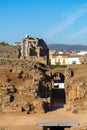 View of the ruins of the architectural complex of the Amphitheater and Roman Theater of Merida and houses of the urban area in Royalty Free Stock Photo