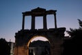 View of the Ruins of archway Hadrians Arch Temple Olympian Zeus Athens during sunset with moon in Athens in Greece - low light Royalty Free Stock Photo