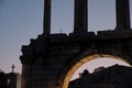View of the Ruins of archway Hadrians Arch Temple Olympian Zeus Athens during sunset with moon in Athens in Greece - low light Royalty Free Stock Photo