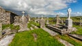 View of the ruins of the medieval church of Killilagh and the graveyard in the village of Doolin