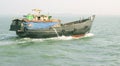 View of running wooden boat at deep river