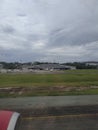 View of the runway from the airplane window while landing.