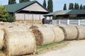 Hay bales are stacked in large stacks on an unknown riding centre Royalty Free Stock Photo