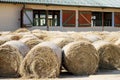 Hay bales are stacked in large stacks on an unknown riding centre Royalty Free Stock Photo