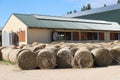 Hay bales are stacked in large stacks on an unknown riding centre Royalty Free Stock Photo