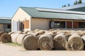 Hay bales are stacked in large stacks on an unknown riding centre Royalty Free Stock Photo