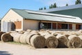 Hay bales are stacked in large stacks on an unknown riding centre Royalty Free Stock Photo