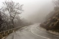 Rural road in the mountains in winter Epirus region, Greece on a cloudy, foggy day