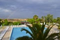 A view of a rural landscape, swimming pool and rainbow