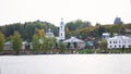 View on russian historical town Plyos on the Volga River from moving cruise ship at sunset