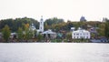 View on russian historical town Plyos on the Volga River from moving cruise ship at sunset