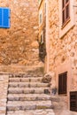 Alley staircase in old villiage with rustic mediterranean stone houses Royalty Free Stock Photo