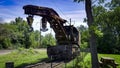 View of a Rusting of Train Steam Crane sitting on a Track Rusting Away