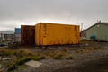 View of rusty containers in a field under the cloudy sky Royalty Free Stock Photo