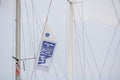 View of sail and flag of sailboat docked at the pier Royalty Free Stock Photo