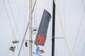 View of sail and flag of sailboat docked at the pier