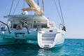 Sailing catamaran in blue waters of the Aegean sea.