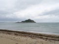 View of Saint Michael\'s Mount Cornwall England from beach with sea weeds