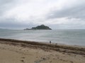 View of Saint Michael\'s Mount in Cornwall England from beach with sea weeds