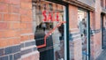 View of sale sign on a glass of a shop in Manchester, The UK