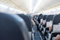 View of salon commercial aircraft. Takeoff or landing. Rows of seat with passengers Royalty Free Stock Photo