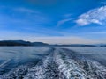 Close up of ocean water creating wakes and waves behind a ferry boat in the Pacific Ocean