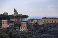 View of San Rocco di Camogli church with some colored buildings in Camogli, province of Genova, Italy