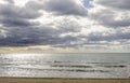 View from sand beach of heavy mediteranean sea with waves and cl Royalty Free Stock Photo