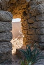 View of a sand dune through a gap in the ruins of a Roman aqueduct in Caesarea, northern Israel