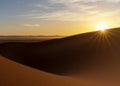 view of the sand dunes at Erg Chebbi in Morocco at sunset with a sunstar Royalty Free Stock Photo
