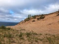 View of sand dunes from hilltop in state park in Michigan