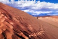 View of sand dunes and rocky hills in the Mars Valley near San Pedro de Atacama against a blue dramatic sky above Royalty Free Stock Photo