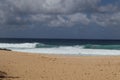 View of the sandy beach against the background of the Pacific Ocean and cloudy sky. Oahu, Hawaii. Royalty Free Stock Photo