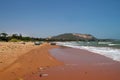 View on a sandy beach near to sea and fishing village with a lot of garbage. Pollution of a coastline. Royalty Free Stock Photo