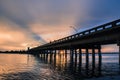 View of Sarasota Bay, Florida near Siesta Key Beach at sunset with view of road bridge disappearing into the distance. Colorful sk Royalty Free Stock Photo